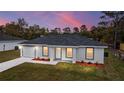 Newly constructed single-Gathering home with a gray roof and landscaping at 13371 Sw 112Th Pl, Dunnellon, FL 34432