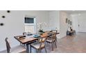 Elegant dining room with a live-edge wood table and modern chairs at 5802 Le Marin Way, Kissimmee, FL 34758