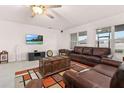 Living room with brown leather couches and a large TV at 313 Auburn Grove Xing, Auburndale, FL 33823