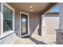 Front entry with stone accents, double door entry and covered porch at 251 Tomelloso Way, Davenport, FL 33837