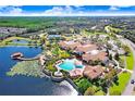 Aerial view of community with clubhouse, pool, and lake at 251 Tomelloso Way, Davenport, FL 33837