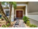 Inviting front entrance with a double door and brick pathway at 4615 Cumbrian Lakes Dr, Kissimmee, FL 34746