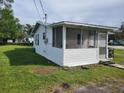 White cottage with screened porch at 1058 N Davis Ave, Lakeland, FL 33805