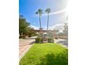 Gated community entrance with palm trees and landscaping at 901 Las Fuentes Dr, Kissimmee, FL 34746