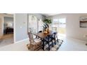 Bright dining room with wooden table, sliding glass door, and modern decor at 1624 Marksman Rd, Eagle Lake, FL 33839