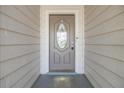 Inviting entryway with gray door and siding at 2305 Flaming Arrow Dr, Lakeland, FL 33813