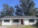 Newly renovated home with a red door and shutters at 1049 Edith Ave, Lakeland, FL 33805