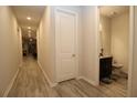 Hallway with light flooring and powder room at 10365 Church Hammock Rd, Leesburg, FL 34788