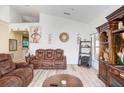 Spacious living room featuring hardwood floors, comfortable seating, and built-in shelving at 163 Andalusia Loop, Davenport, FL 33837