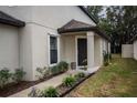 Front entrance with dark door, walkway, and landscaping at 6298 Manitoba Dr, Lakeland, FL 33805