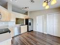 Bright kitchen with stainless steel appliances and wood-look flooring at 7713 Manor Dr, Lakeland, FL 33810