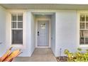 Inviting front entrance with a light blue door and landscaping at 254 Glasgow Ct, Davenport, FL 33897