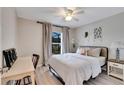 Spacious bedroom with a queen bed, desk, and large window at 254 Glasgow Ct, Davenport, FL 33897