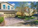 Front view of two-story house with a two-car garage and landscaping at 2821 Shady Willow Ln, Oviedo, FL 32765