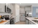 Modern kitchen with stainless steel appliances and white cabinetry at 1886 Rider Rain Ln, Apopka, FL 32703