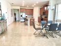 Open concept kitchen and dining area with modern glass table and chairs at 4552 Sequel Rd, Kissimmee, FL 34746