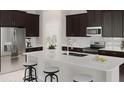 Modern kitchen with stainless steel appliances and an island at 5014 Barnet Dr, Davenport, FL 33837