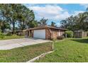 Brick home with attached garage and large yard at 4042 Stonehenge Rd, Mulberry, FL 33860