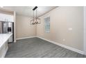 Bright dining area with gray vinyl plank flooring and a modern chandelier at 7737 Somersworth Dr, Kissimmee, FL 34747