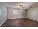 Spacious bedroom with dark wood-look floors and ceiling fan at 910 N Lincoln Ave, Lakeland, FL 33815