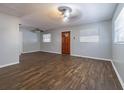 Bright living room with dark wood-look floors and ceiling fan at 910 N Lincoln Ave, Lakeland, FL 33815