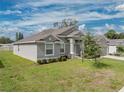 One-story home with gray siding, landscaping at 232 Samantha Ave, Auburndale, FL 33823