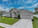 One-story home with gray siding and two-car garage at 232 Samantha Ave, Auburndale, FL 33823
