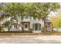 Two-story house with gray siding, stone accents, and a tree-lined street at 3366 Cat Brier Trl, Harmony, FL 34773
