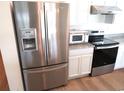 Stainless steel refrigerator, microwave, and stove at 148 Summerlin Loop, Haines City, FL 33844