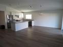 Open concept kitchen and dining area with light wood floors at 148 Summerlin Loop, Haines City, FL 33844