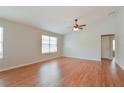 Bright and airy living room with hardwood floors and ceiling fan at 2572 Berrington Loop, The Villages, FL 32162