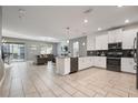Modern kitchen with white cabinets, stainless steel appliances and an island at 4550 Narrative Ln, Kissimmee, FL 34746