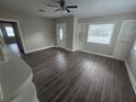 Spacious living room with built-in shelving and hardwood floors at 1124 Sunshine Ave, Leesburg, FL 34748