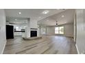 Open concept kitchen and living area with new appliances and hardwood floors at 1646 Center St, Deland, FL 32720