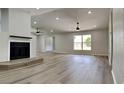 Bright living room with hardwood floors, fireplace, and ceiling fan at 1646 Center St, Deland, FL 32720