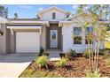 One-story house with gray and white exterior, one-car garage, and landscaping at 10560 Sw 49Th Avenue Rd, Ocala, FL 34476