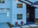 Stylish house exterior with white and dark gray siding, and landscaping at 716 W 14Th St, Lakeland, FL 33805