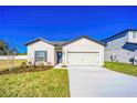 Newly constructed one-story house with a two-car garage and neatly landscaped front yard at 13470 Leaping Water Way, Astatula, FL 34705