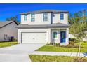 Two-story house with a two-car garage and landscaped lawn at 13474 Leaping Water Way, Astatula, FL 34705