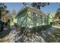 Side view of a light green house with hedges at 1111 Royal Ridge Dr, Davenport, FL 33896