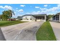 Front view of manufactured home with driveway and landscaping at 1610 Reynolds Rd # 159, Lakeland, FL 33801