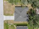 Top-down view of a single-story house with a gray roof and a concrete driveway at 1312 Congo Dr, Poinciana, FL 34759