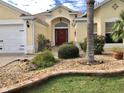 Close-up view of the home's landscaped front yard, walkway, and inviting entryway at 2196 Kershaw Rd, The Villages, FL 32162