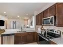 Modern kitchen with dark wood cabinets, stainless steel appliances, and quartz countertops at 5414 Sw 85Th Avenue Rd, Ocala, FL 34481