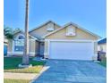 Attractive single-story home with a two-car garage and well-manicured lawn at 2622 Montego Bay Blvd, Kissimmee, FL 34746