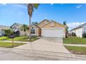 House exterior view, showcasing a driveway and landscaping at 2622 Montego Bay Blvd, Kissimmee, FL 34746