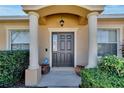 Dark brown front door with columns and landscaping at 1975 Country Manor St, Bartow, FL 33830