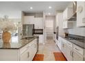 Modern kitchen with white cabinets, granite countertops, and stainless steel appliances at 10909 Se 168Th Loop, Summerfield, FL 34491