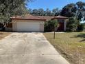 House exterior showcasing a red tile roof and driveway at 901 Hickory Rd, Ocala, FL 34472