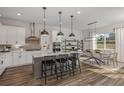 Modern kitchen with white cabinets, gray island, and stainless steel appliances at 4440 Sw 84Th Street Rd, Ocala, FL 34476